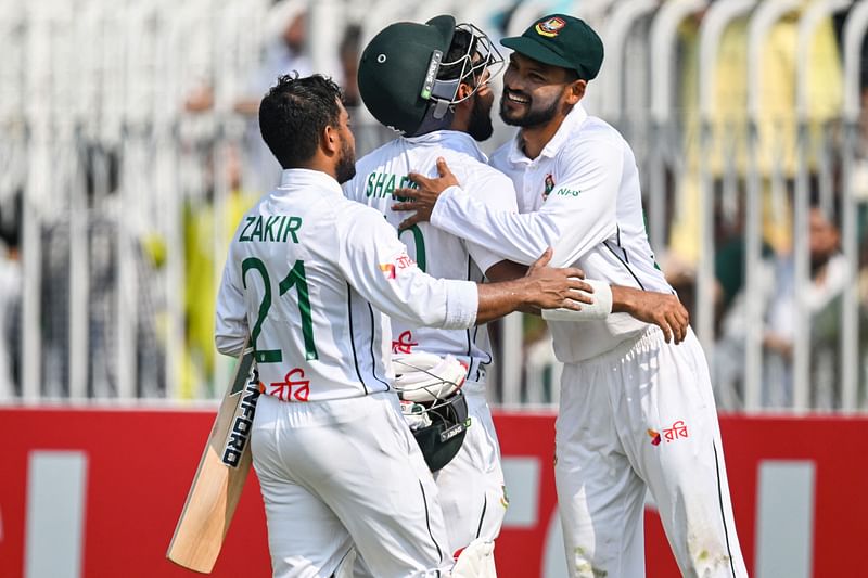 Bangladesh’s Shadman Islam (C) and Zakir Hasan (L) is greated by captain Najmul Hossain Shanto after their team’s win at the end of the fifth and final day of the first Test cricket match between Pakistan and Bangladesh at the Rawalpindi Cricket Stadium in Rawalpindi on 25 August 2024